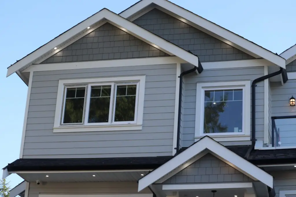 Low-angle view of modern houses in the background of sky