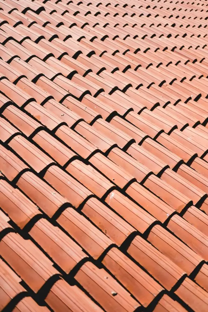 Rows of overlapping terracotta roof tiles arranged in a uniform, repeating pattern.